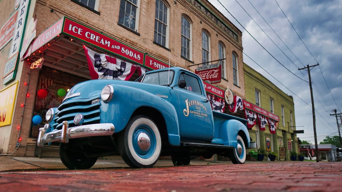 Vintage blue truck outside the Jefferson General Store in downtown Jefferson, Texas