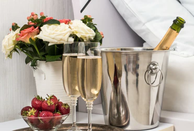 Seasonal fruit, chocolate, and sparkling wine arranged for a celebration